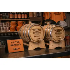 Custom 5-liter whiskey barrels as promotional merchandise displayed with branded items in a retail or distillery setting.