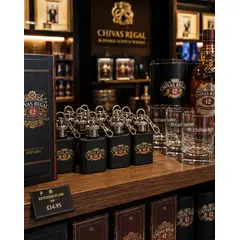 Custom branded 1 oz keychain flasks displayed in a distillery gift shop alongside whiskey merchandise, glassware, and premium spirits products.