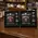 Branded flask gift sets displayed on distillery retail counter with whiskey bottles and merchandise in background