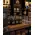 Custom branded 1 oz keychain flasks displayed in a distillery gift shop alongside whiskey merchandise, glassware, and premium spirits products.