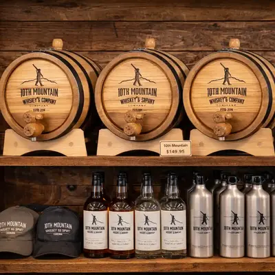 10th Mountain Whiskey custom oak aging barrels displayed on retail shelf with branded bottles and merchandise in distillery gift shop