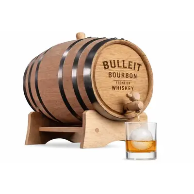 Custom engraved 5-liter oak whiskey barrel promotional product with logo, dispensing bourbon into a glass with a large ice sphere.